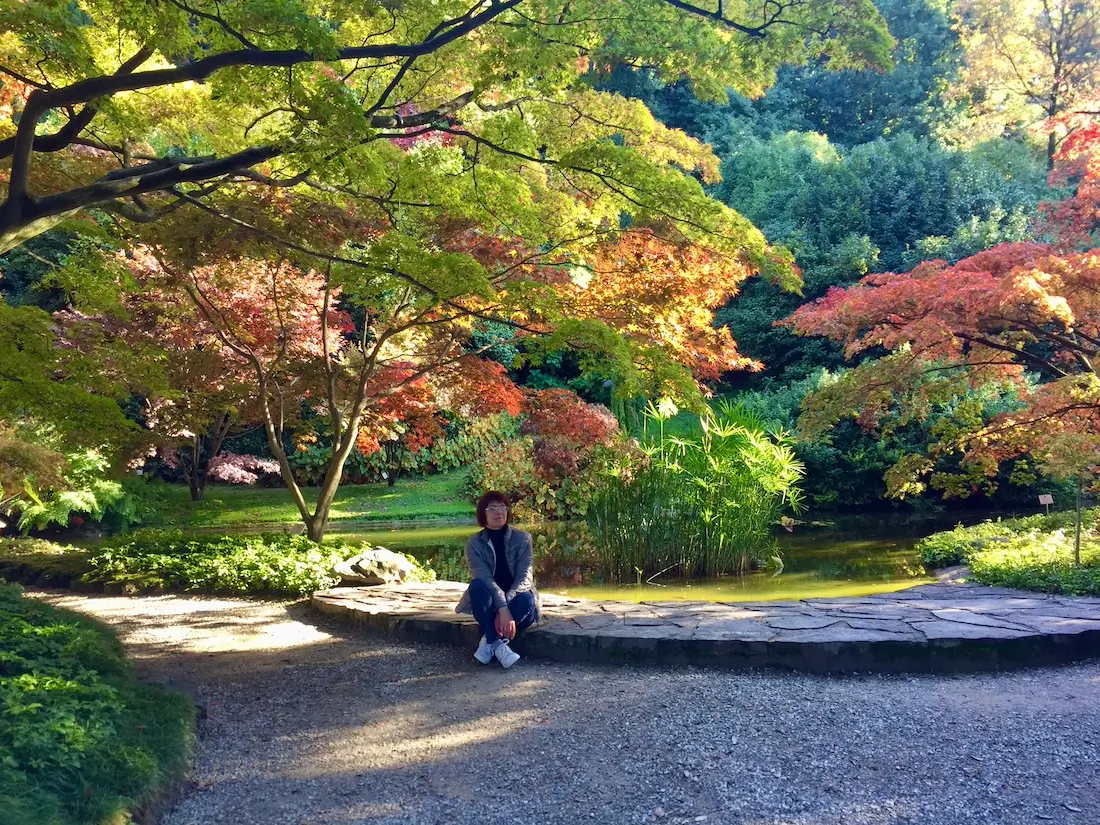 the gardens of Villa Melzi trees with Antonella sit on a stone step